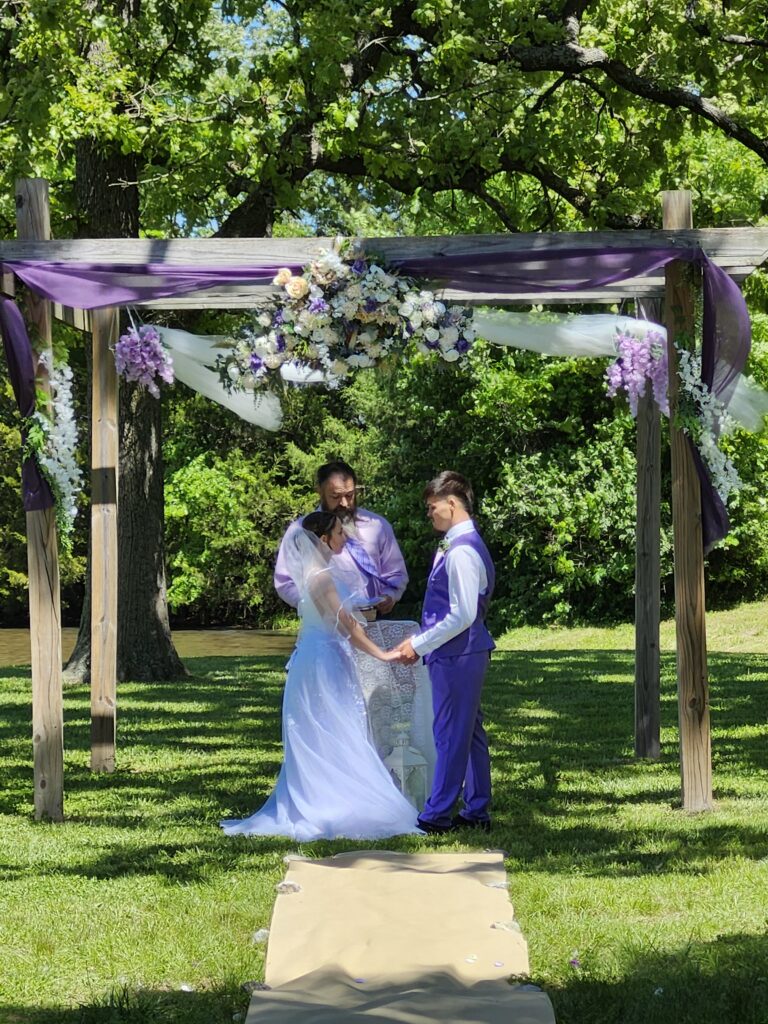 Lavender and sage green spring wedding ceremony arbor details at Country Charm Venue
